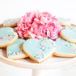 Horizontal photo of a batch of Valentine Shortbread Cookies on a white pedestal serving plate.