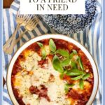 Vertical overhead photo of a pan of Make-Ahead Ravioli Lasagna with a large text graphic at the top of the photo.