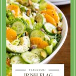 Vertical closeup photo of an Irish Flag Clementine Cucumber Salad in a white serving bowl with a black word graphic title at the bottom of the photo.