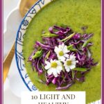 Vertical overhead photo of a bowl of Thai Broccoli Spinach Soup garnished with sliced red cabbage and decorated with white flowers. A text graphic title is at the bottom of the photo.