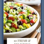 Vertical closeup photo of The BEST Greek Salad in a white marble serving bowl.