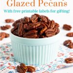 Vertical closeup photo of a batch of Southwestern Sweet and Spicy Glazed Pecans in a pale blue ramekin bowl with a large test graphic at the top of the photo.