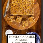 Overhead vertical photo of a batch of Honey Caramel Almond Shortbread Bars on a round wood plate with a text title graphic at the bottom of the picture.
