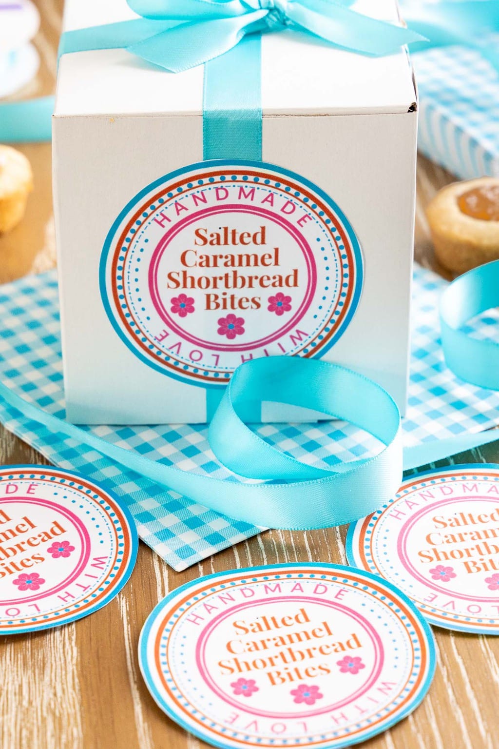 Vertical closeup photo of custom labels and a gift box for Ridiculously Easy Salted Caramel Shortbread Bites.