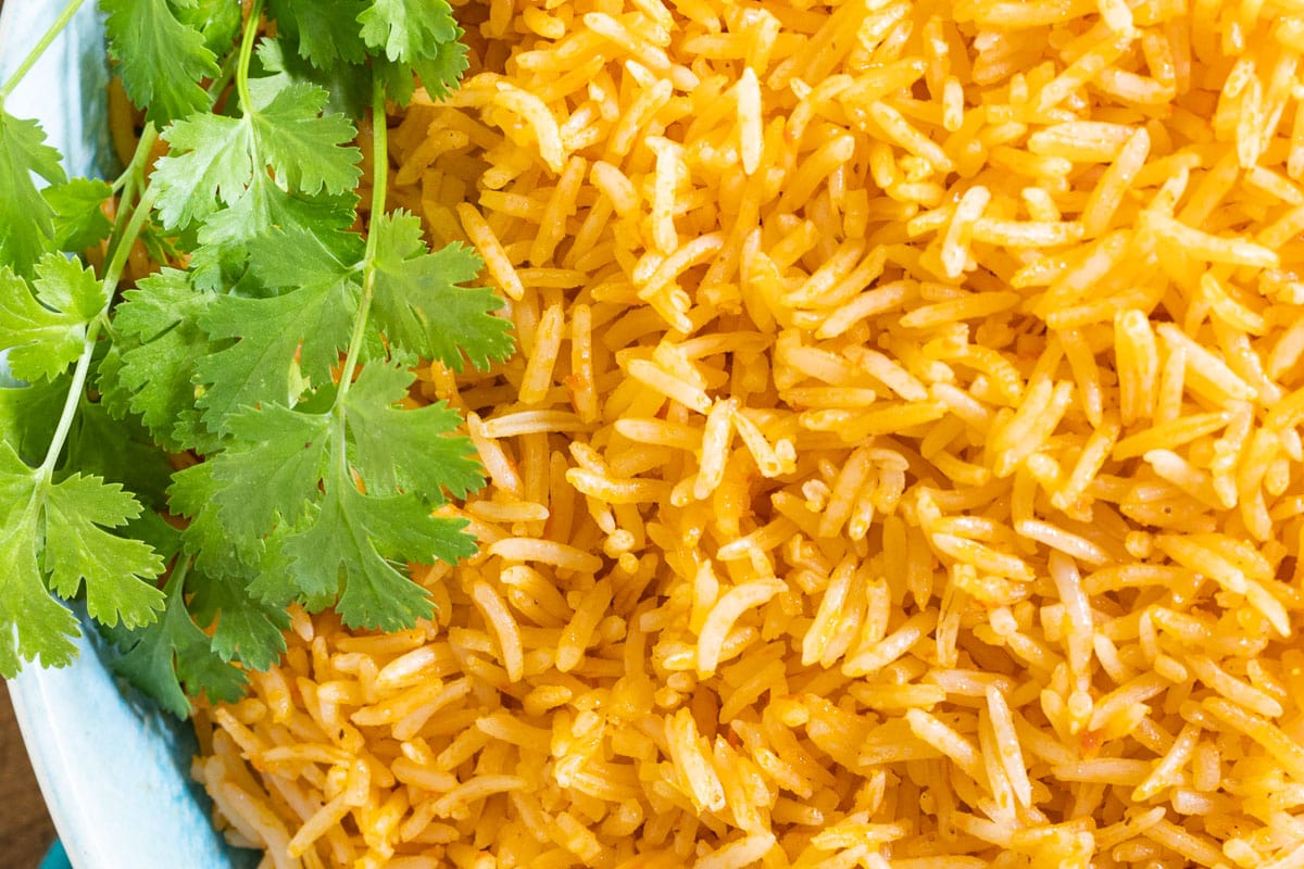 Horizontal overhead closeup photo of Dulce's Delicious, Easy Mexican Rice garnished with cilantro.