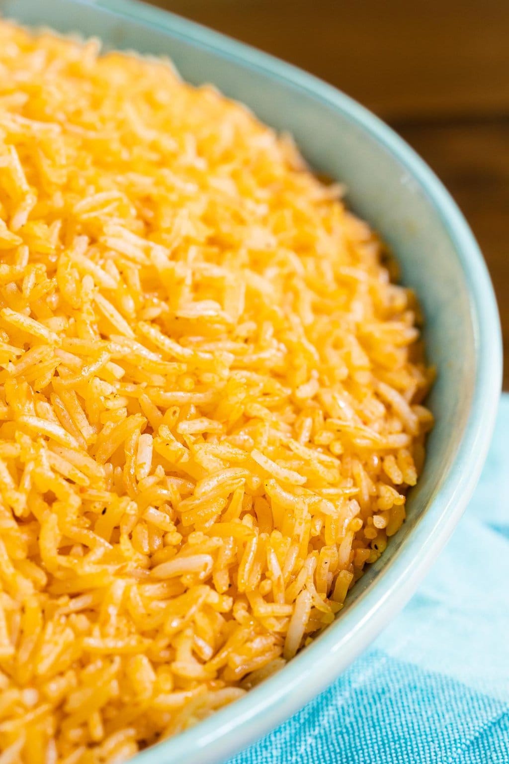 Vertical closeup photo of a serving bowl of Dulce's Delicious, Easy Mexican Rice.