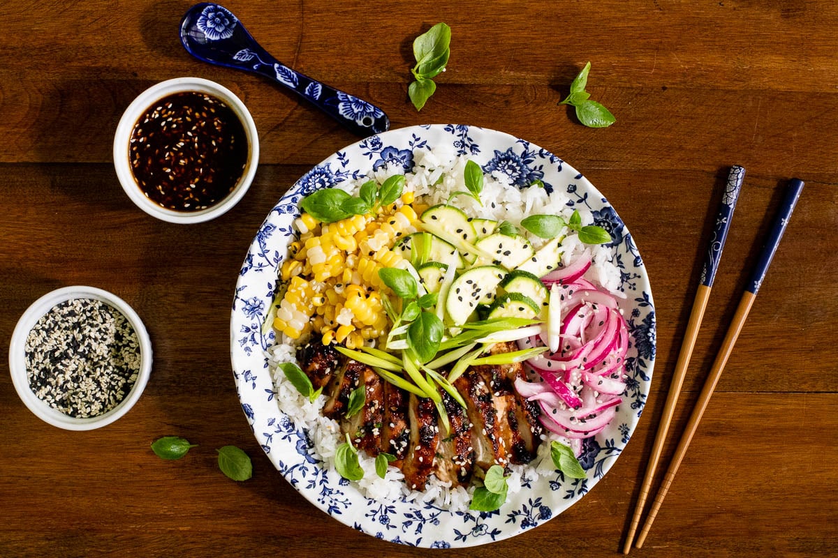 Overhead horizontal photo of Korean Grilled Chicken on a wood table.