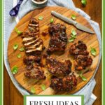 Vertical overhead photo of a cutting board of Grilled Korean Honey Sesame Chicken.