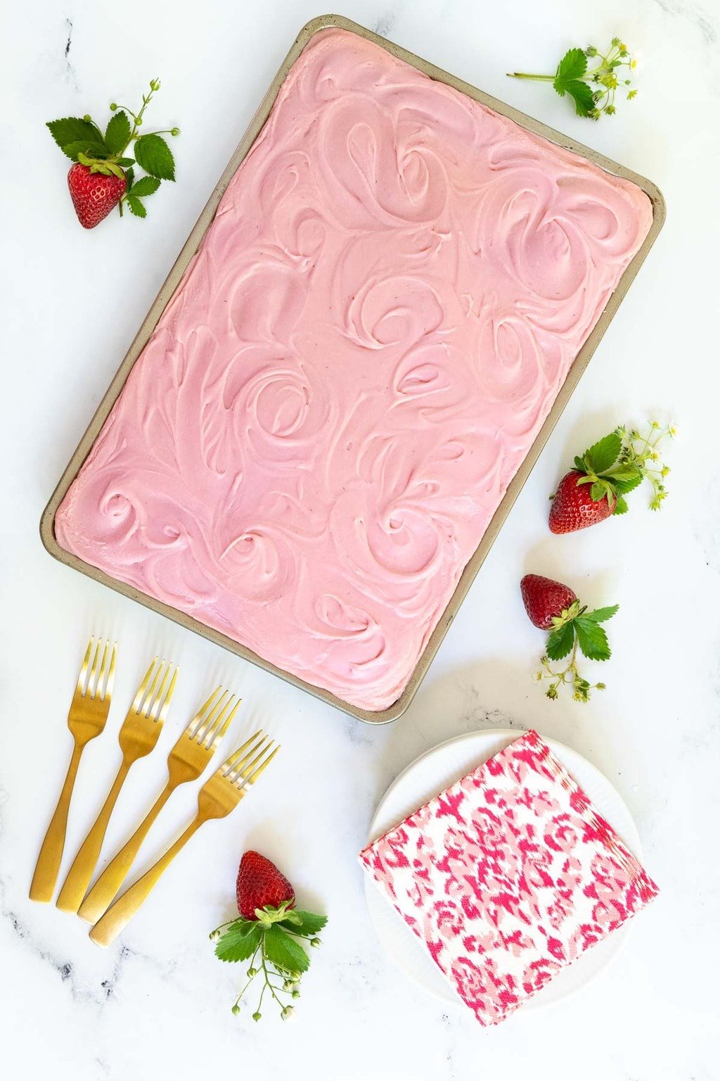 Vertical overhead photo of a Vanilla Bean Sheet Cake with Fresh Strawberry Icing.