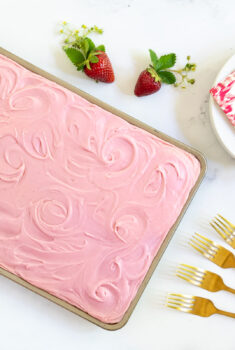 Horizontal overhead photo of a Vanilla Bean Sheet Cake with Fresh Strawberry Icing.
