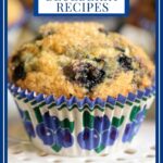 Vertical extreme closeup photo of a Blueberry Muffin on a white lattice pedestal serving plate.