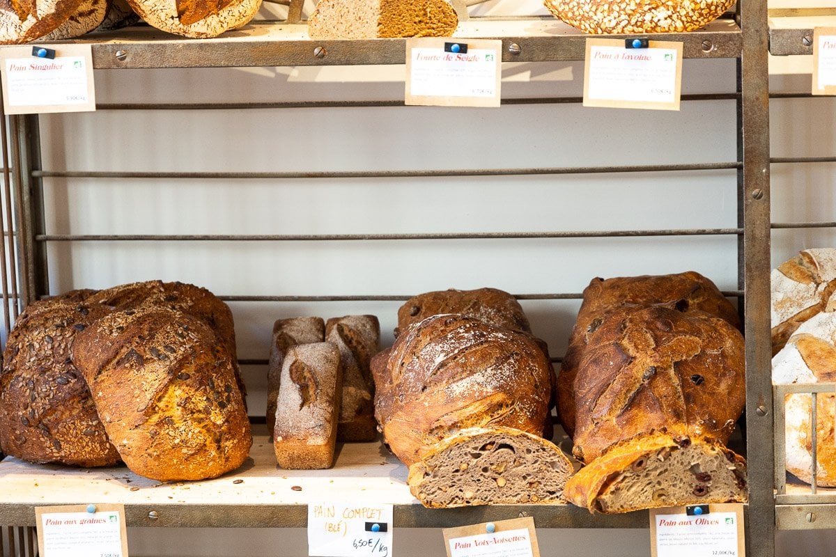Horizontal photo of breads at one of the boulangeries at the French market in Lyon, France.