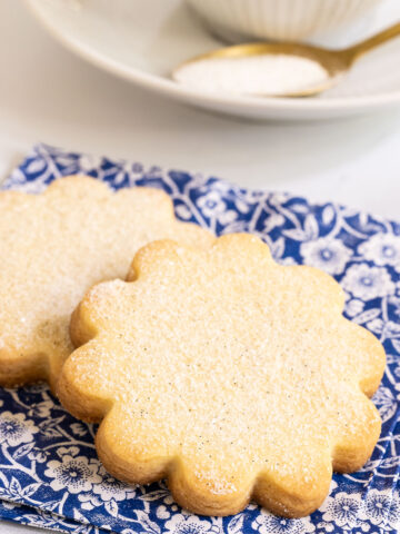 Vertical picture of French Shortbread Cookies on a blue and white floral print napkin