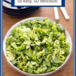 Vertical photo of a Classic French Bistro Salad in a white serving bowl on a wood table with a title text caption at the top.