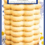 Vertical extreme closeup photo of a stack of French Shortbread Cookies (Sablés Bretons) on a blue and white patterned napkin with a title caption at the top of the photo.