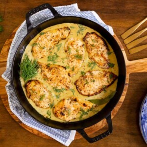 Overhead horizontal photo of a pan of French Mustard Chicken on a wood table.