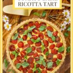 Vertical overhead photo of a French Tomato Ricotta Tart on a wood cutting board with a title graphic at the top of the photo.