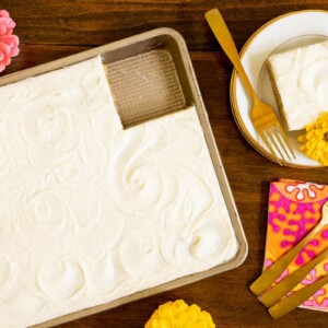 Horizontal overhead photo of a Ridiculously Easy Butterscotch Sheet Cake with a slice on an individual serving plate.