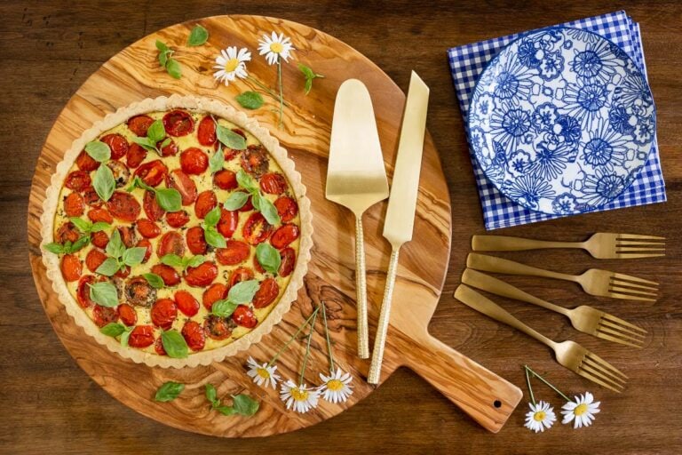 Horizontal overhead photo of a savory tart using the Ridiculously Easy Press-In Tart Crust (for Sweet or Savory Tarts) on a wood cutting board.