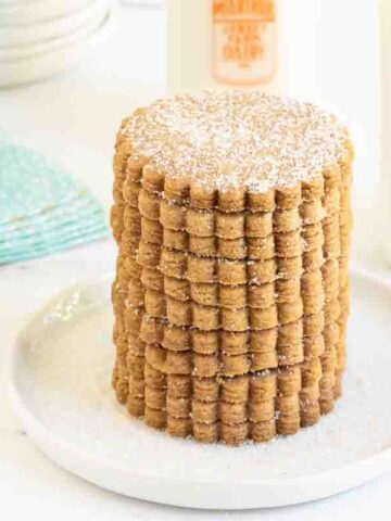Horizontal photo of a stack of Belgian Shortbread Cookies on a white serving plate.