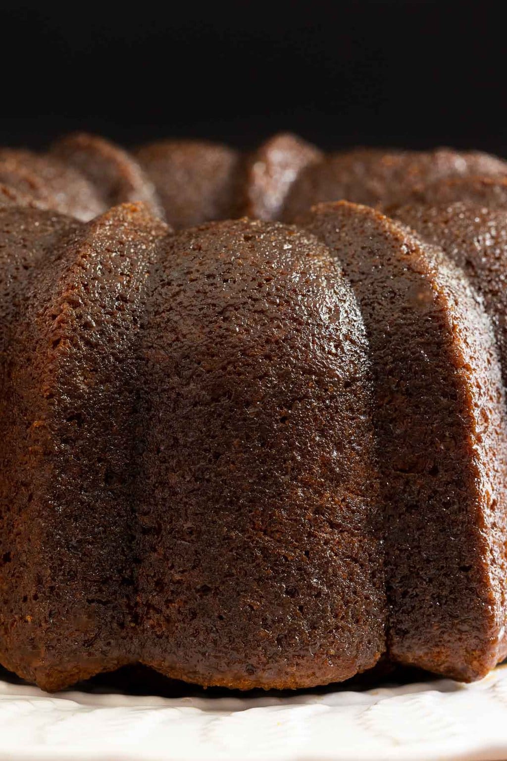 Vertical extreme closeup photo of the side of a Ridiculously Easy Butterscotch Glazed Pumpkin Bundt Cake.