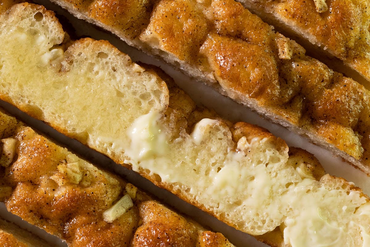 Horizontal extreme closeup photo of slices of Ridiculously Easy Apple Cinnamon Breakfast Focaccia bread.