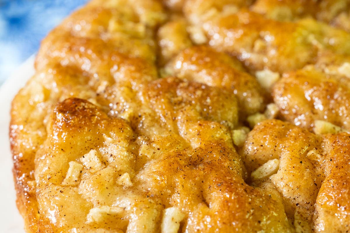 Horizontal extreme closeup photo of the glazed top of a Ridiculously Easy Apple Cinnamon Breakfast Focaccia.