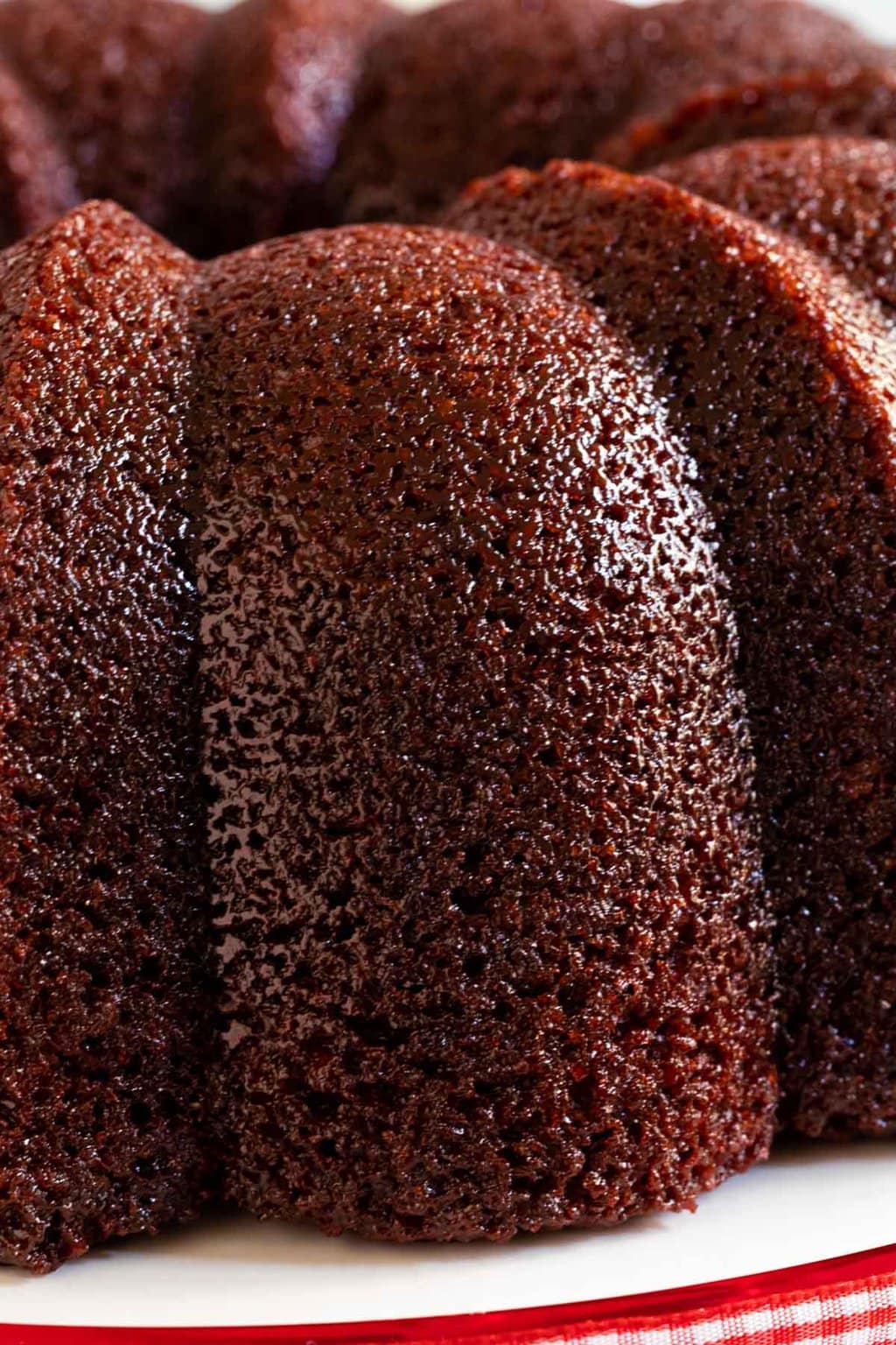 Horizontal extreme closeup photo of a Ridiculously Easy Peppermint-Glazed Red Velvet Bundt Cake highlighting the peppermint glaze.