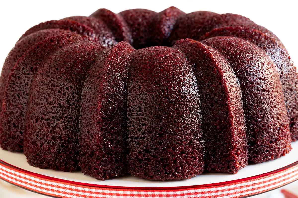 Horizontal closeup photo of a Ridiculously Easy Peppermint-Glazed Red Velvet Bundt Cake.