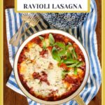 Vertical overhead photo of a skillet of Italian Chicken Sausage Ravioli Lasagna garnished with fresh basil leaves.