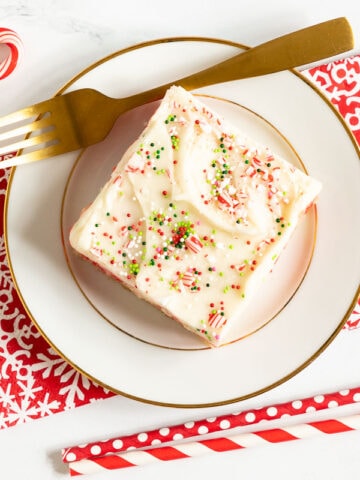 Horizontal overhead photo of a Ridiculously Easy Candy Cane Sheet Cake surrounded by candy canes.