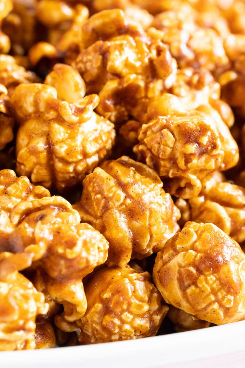 Vertical closeup photo of a batch of Ridiculously Easy Gingerbread Caramel Corn.