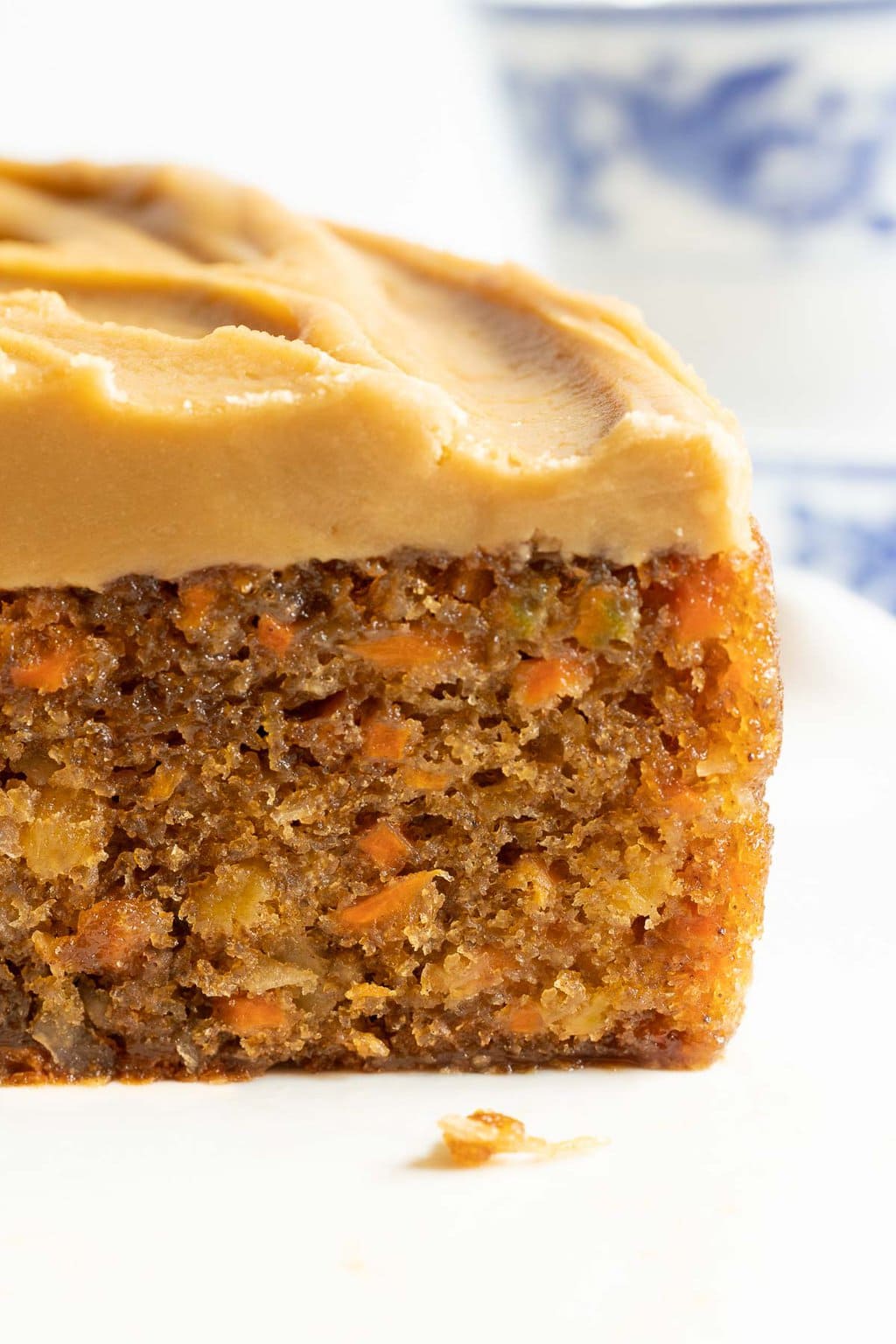 Vertical extreme closeup photo of a Ridiculously Easy Carrot Cake Recipe with Brown Butter Caramel Icing.