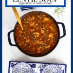 Vertical overhead photo of a cast iron pot of French Lentil Soup on a white granite surface.