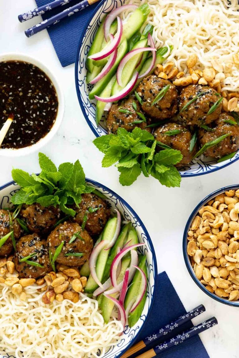 Ginger Scallion Meatballs in bowls with cashews and dipping sauce.