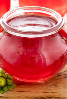Horizontal closeup photo of a jar of Fresh Strawberry Jelly.