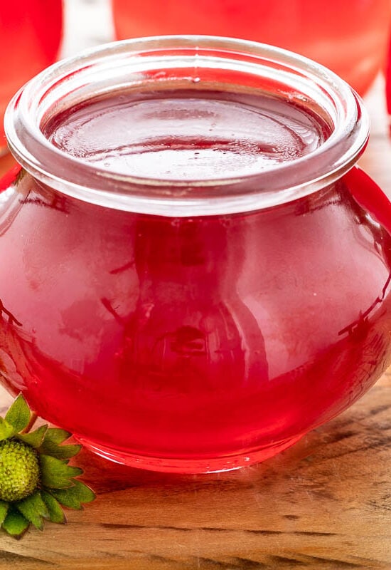 Horizontal closeup photo of a jar of Fresh Strawberry Jelly.
