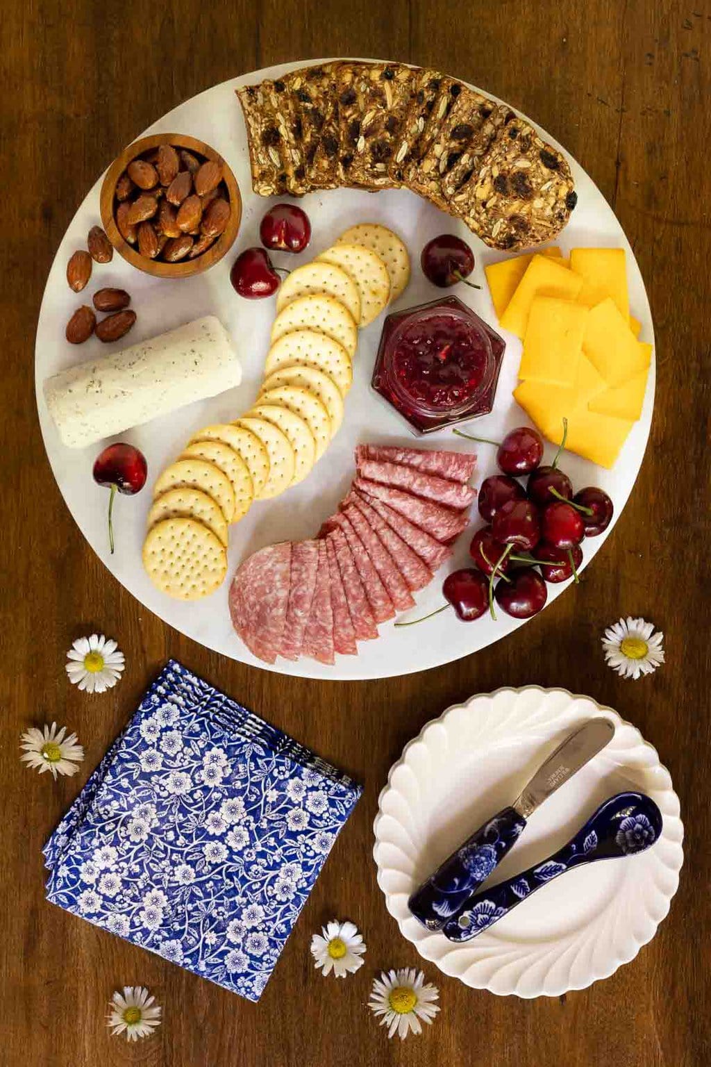 Vertical overhead photo of a charcuterie board featuring Balsamic Sweet Cherry Preserves.