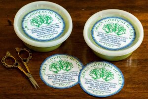 two containers of green goddess hummus ready to gift complete with custom labels