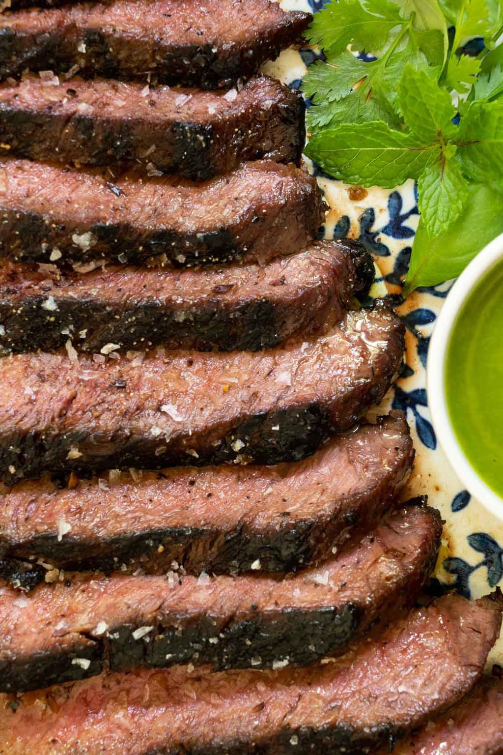 Vertical overhead closeup photo of slices of a Grilled Vietnamese Flat Iron Steak.