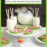 Vertical photo of a batch of Watermelon Shortbread Cookies on a white pedestal plate surrounded by glasses and a pitcher of milk. A text title block is at the top of the photo.