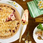 Horizontal overhead photo of a Easy Blackberry Crumble Pie on a wood table.
