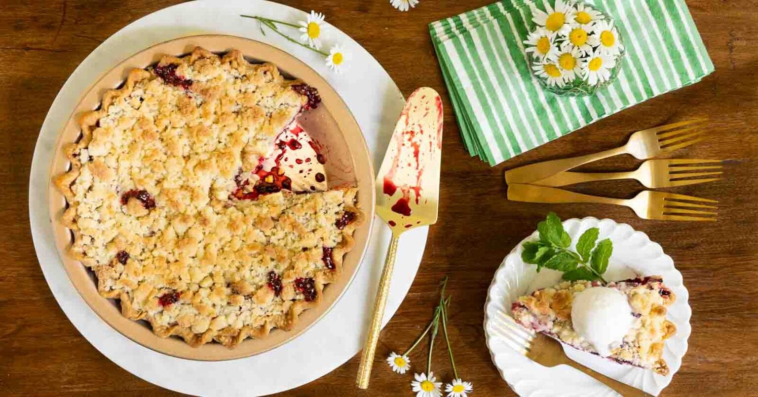 Easy Blackberry Crumble Pie - thecafesucrefarine.com Overhead horizontal photo of an Easy Blackberry Crumble Pie on white marble surface on a wood table.