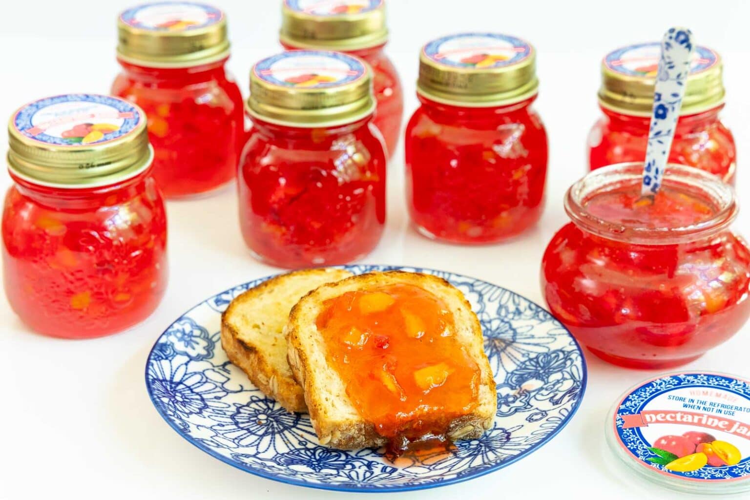 Horizontal photo of jars of Fresh Nectarine Jam with custom labels for gift giving.
