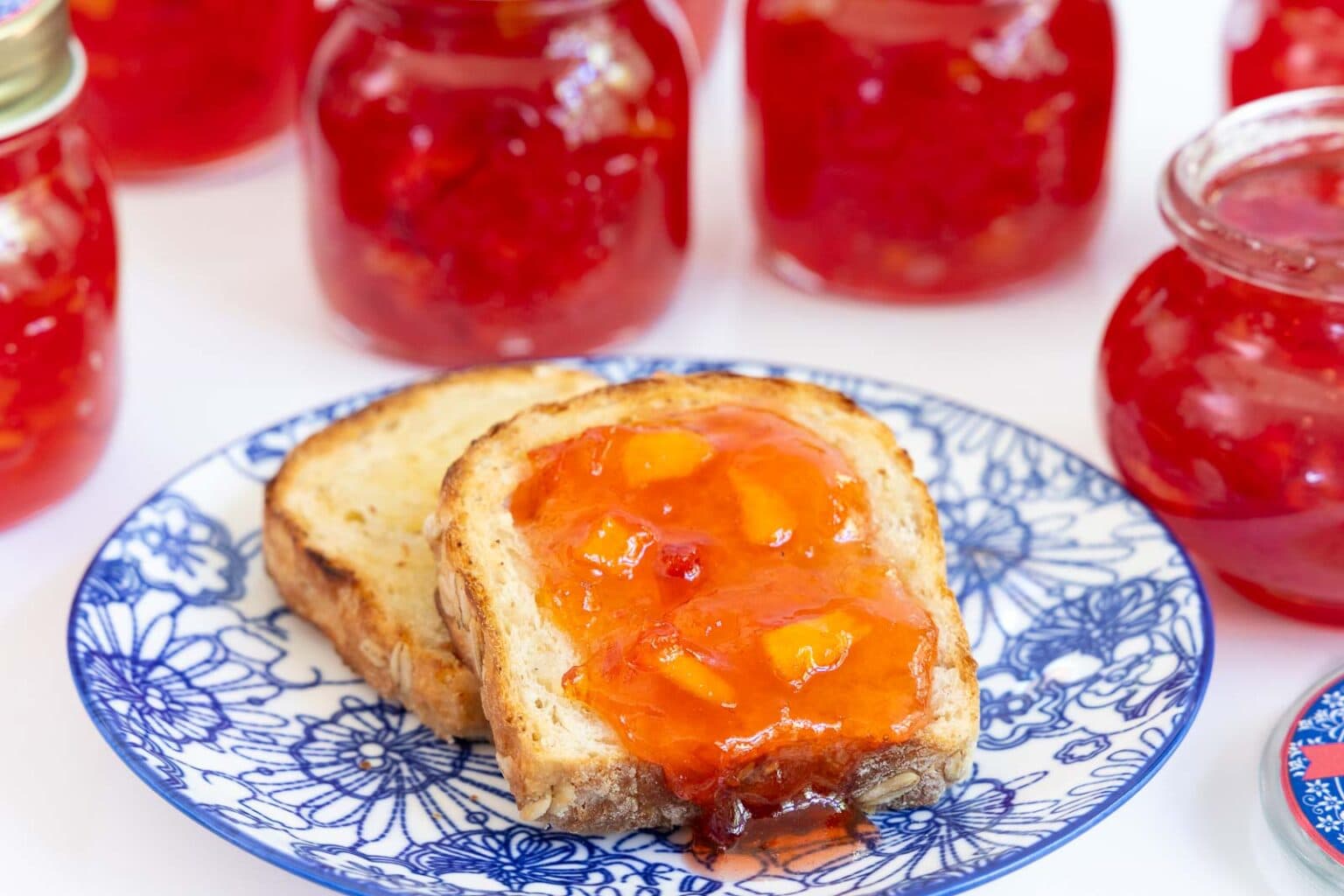 Nectarine Jam - thecafesucrefarine.com Horizontal closeup photo of slices of No-Knead Porridge Bread spread with Fresh Nectarine Jam.