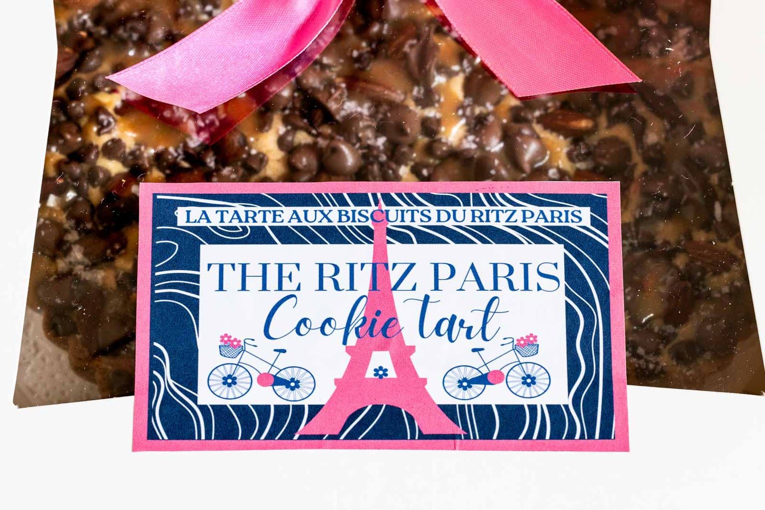 Horizontal closeup photo of a Easy Ritz Paris Cookie Tart in a white box with a custom label for gift giving.