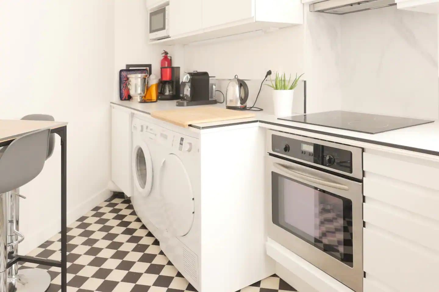 Horizontal photo of the kitchen/laundry in Renee's Air BnB apartment in Paris.