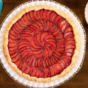 Horizontal overhead photo of a Ridiculously Easy French Plum Galette on a white glass serving plate.
