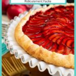 Vertical closeup photo of a Ridiculously Easy French Plum Galette on a white glass pedestal serving plate.