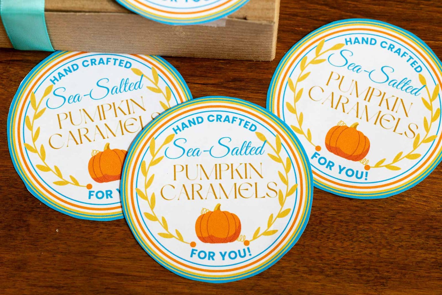 Horizontal overhead photo of Ridiculously Easy Sea-Salted Pumpkin Microwave Caramel custom labels for gift giving.